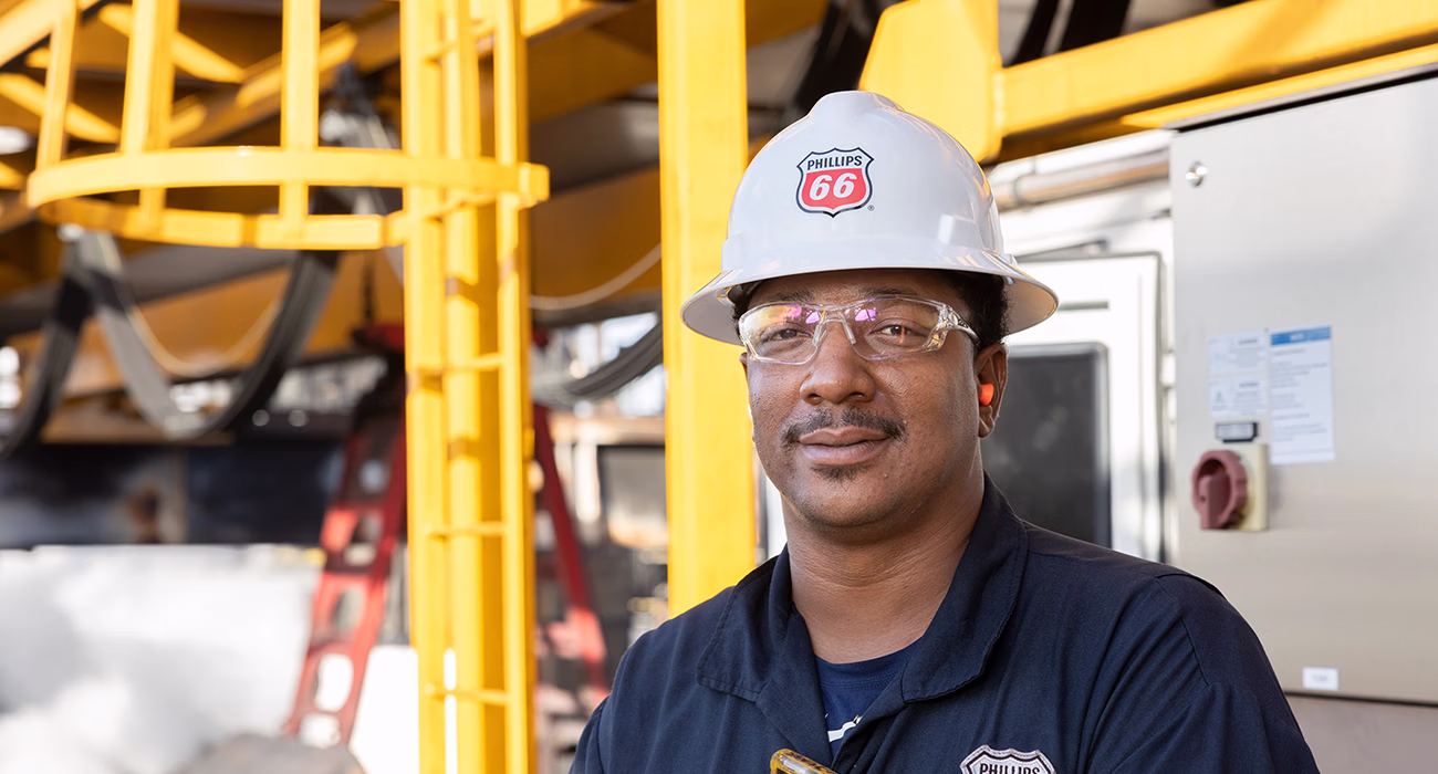 Phillips 66 employee wearing a hard hat and protective glasses