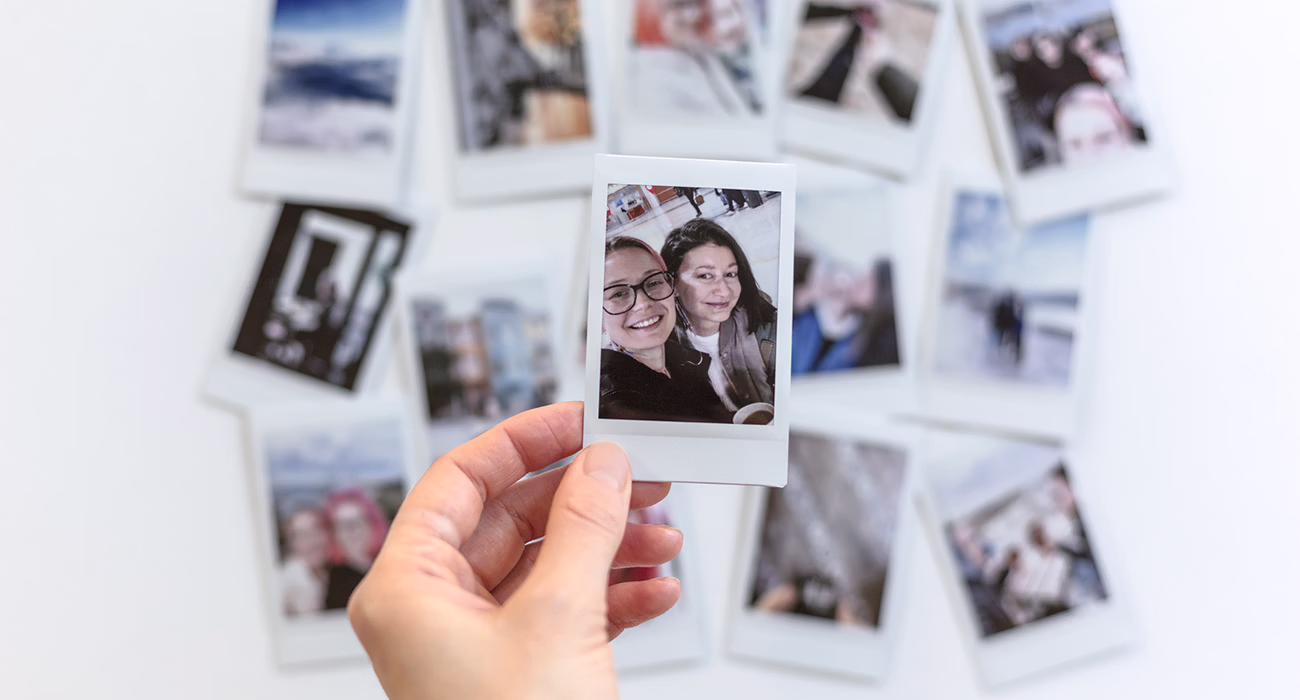 Pile of Printed Memories: A Couple's Journey in Photos